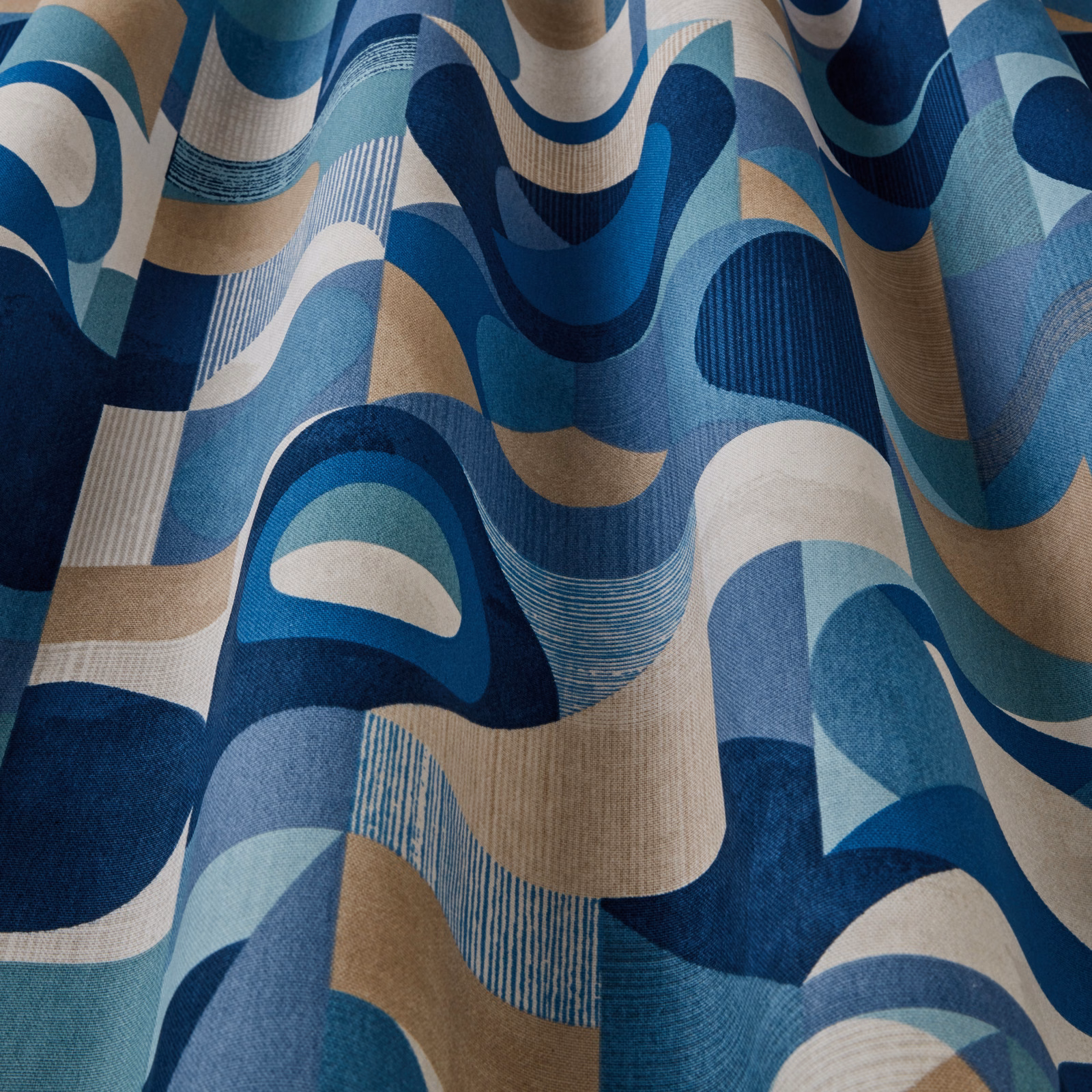 Large-scale wavy geometric fabric in teal, navy, aqua and beige