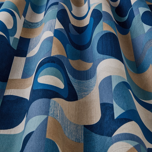 Large-scale wavy geometric fabric in teal, navy, aqua and beige