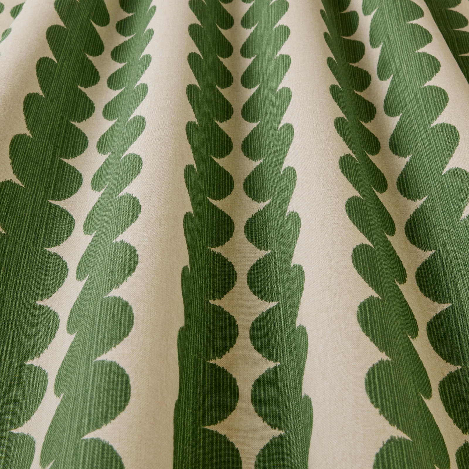 Cream fabric with vertical emerald green scalloped geometric stripes