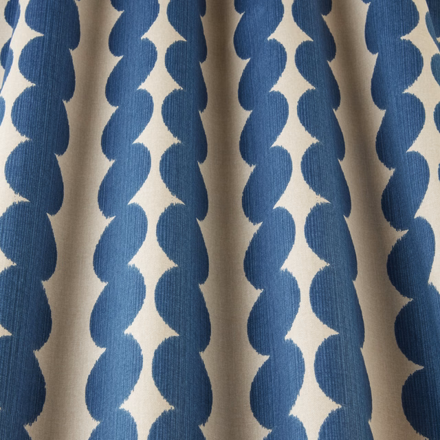 Blue scalloped vertical stripes on an ivory woven fabric swatch