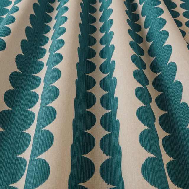 Teal scalloped vertical stripe fabric on an ivory ground, close-up