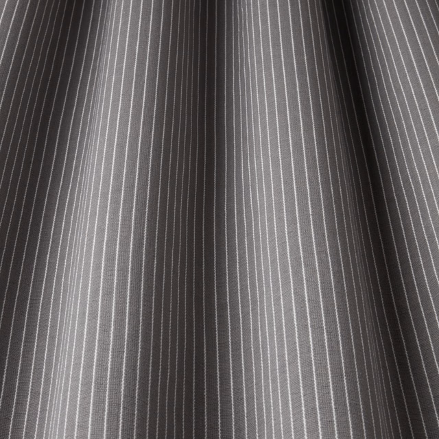 Grey cotton fabric with fine white pinstripes and soft folded drape