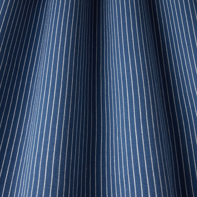 Deep navy cotton fabric with fine vertical white pinstripes and a crisp woven texture.