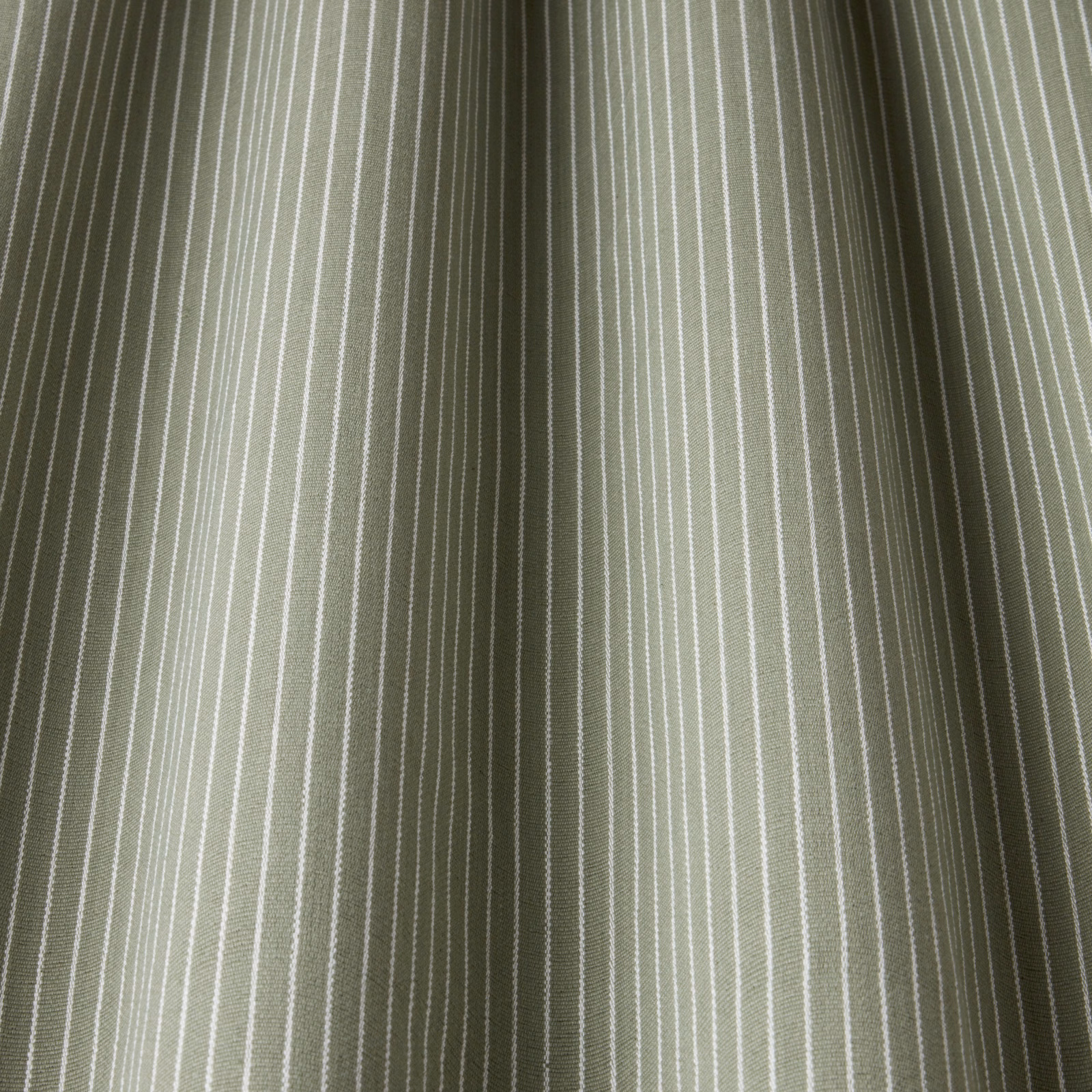 Soft willow green cotton stripe with fine pale pinstripes and gathered folds