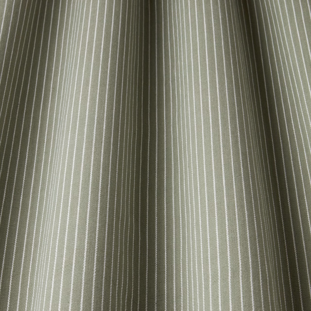 Soft willow green cotton stripe with fine pale pinstripes and gathered folds