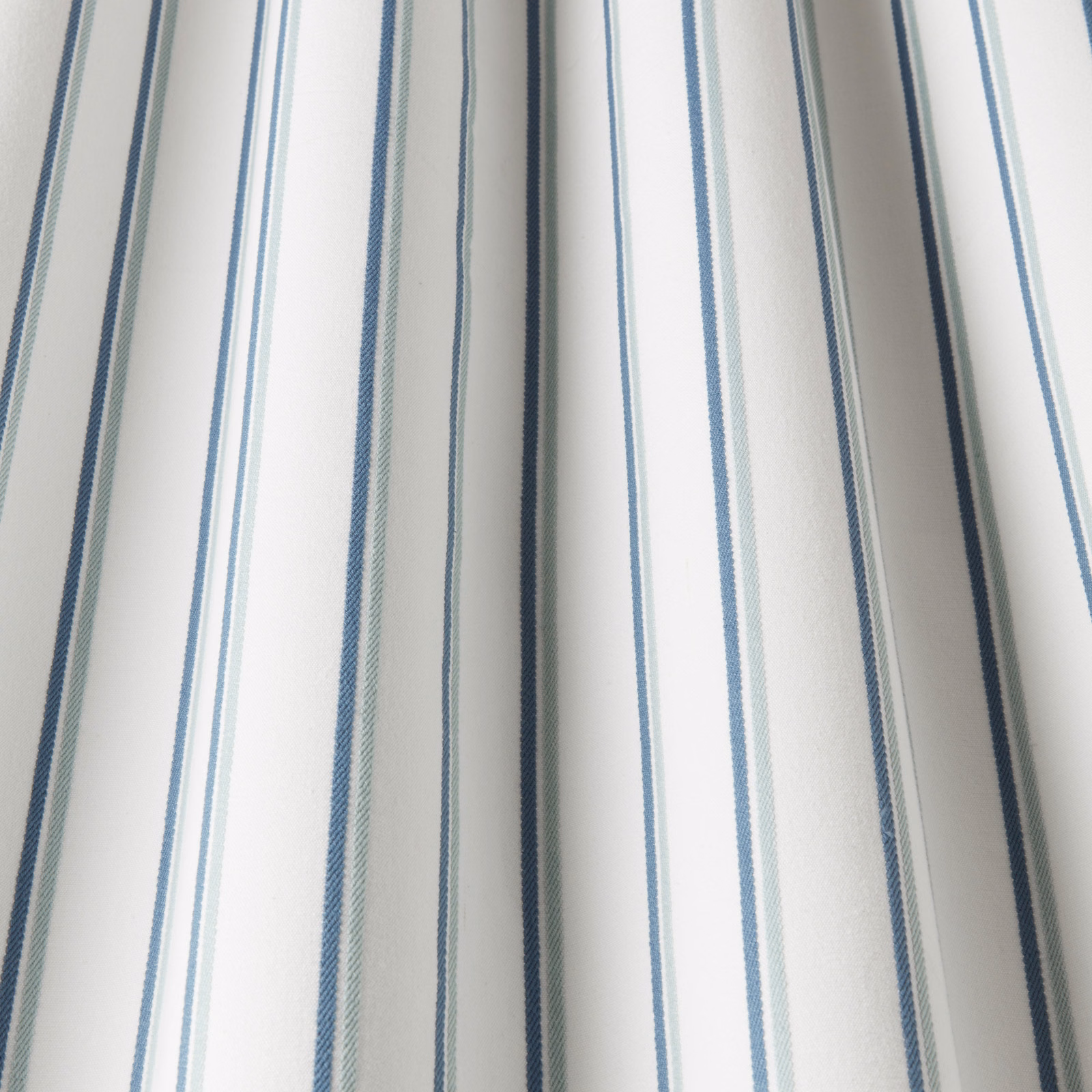 White cotton fabric with narrow aqua and blue vertical stripes