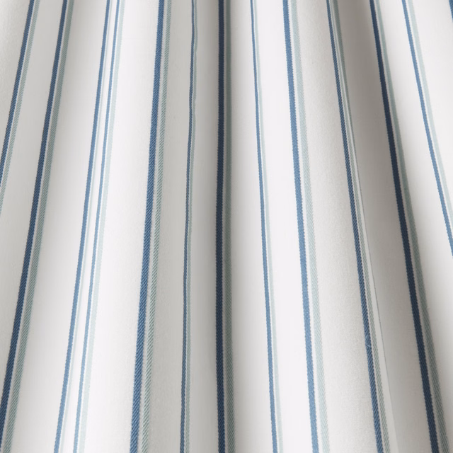 White cotton fabric with narrow aqua and blue vertical stripes