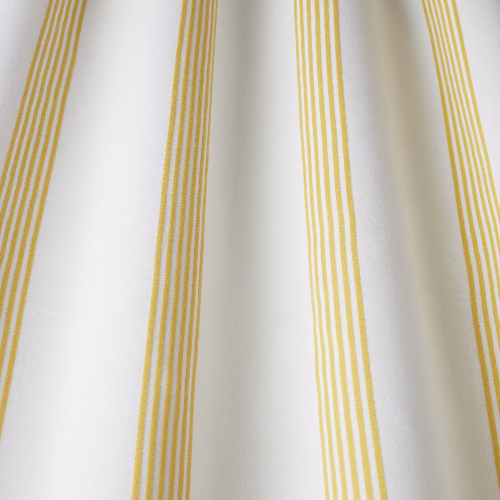 White cotton fabric with narrow vertical citrus yellow stripes