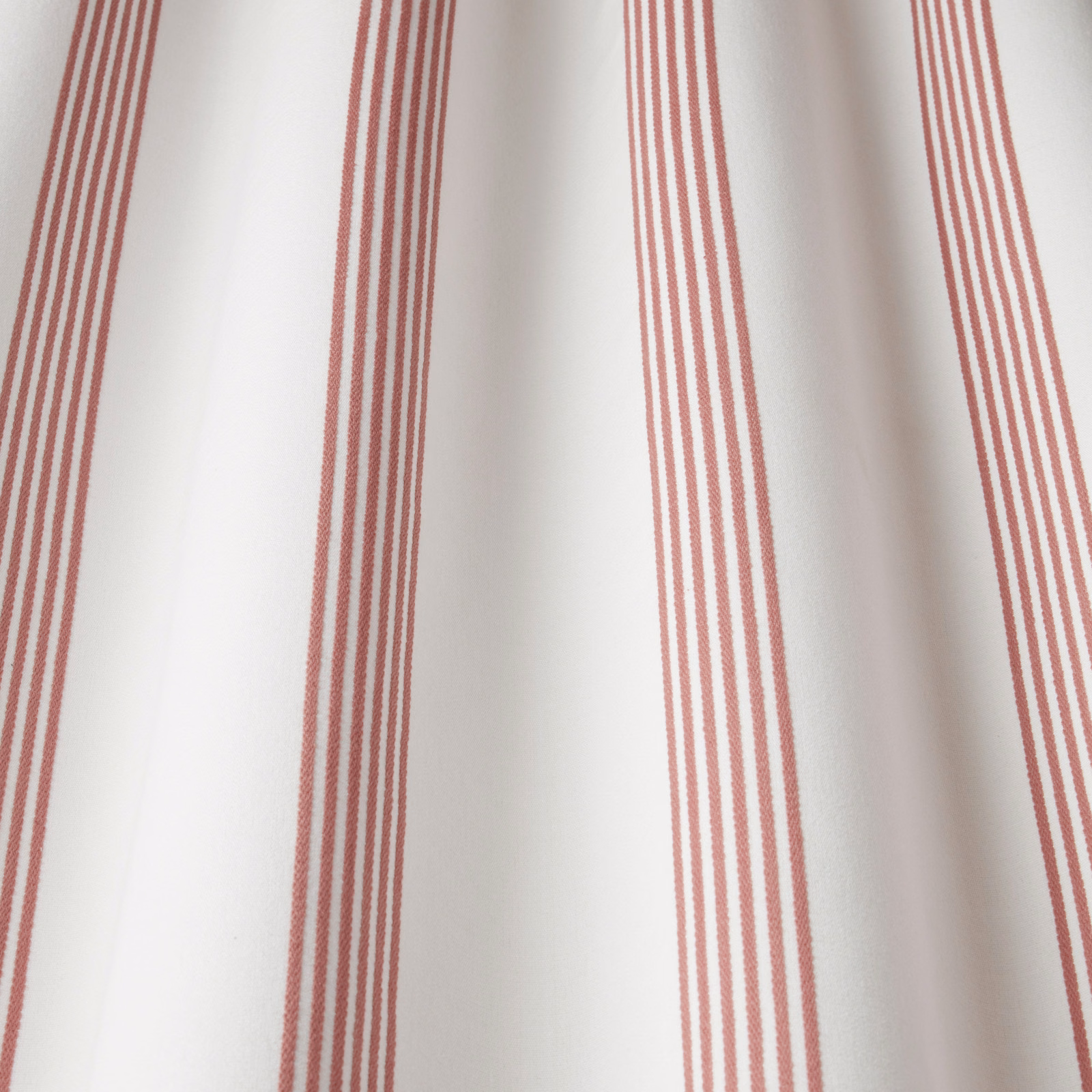 Raspberry pink vertical stripe cotton fabric on a pale ground