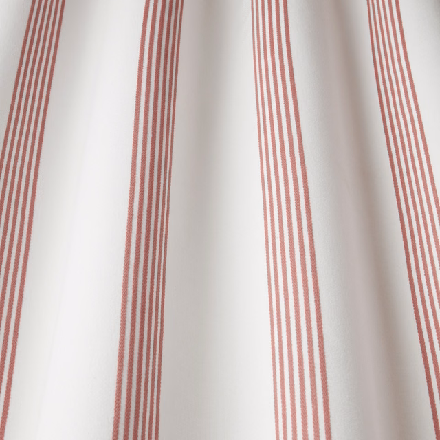 Raspberry pink vertical stripe cotton fabric on a pale ground