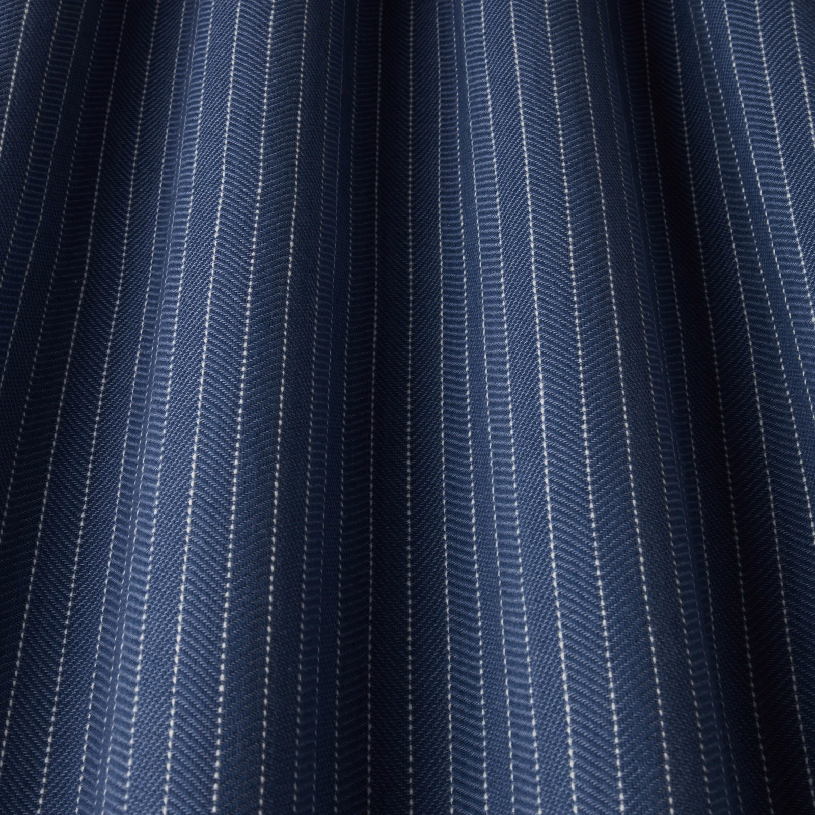 Dark navy cotton fabric with fine vertical pale blue and white stripes
