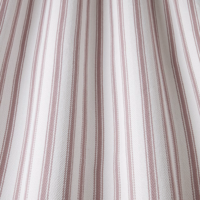 White cotton fabric with slim dusty rose wavy vertical stripes