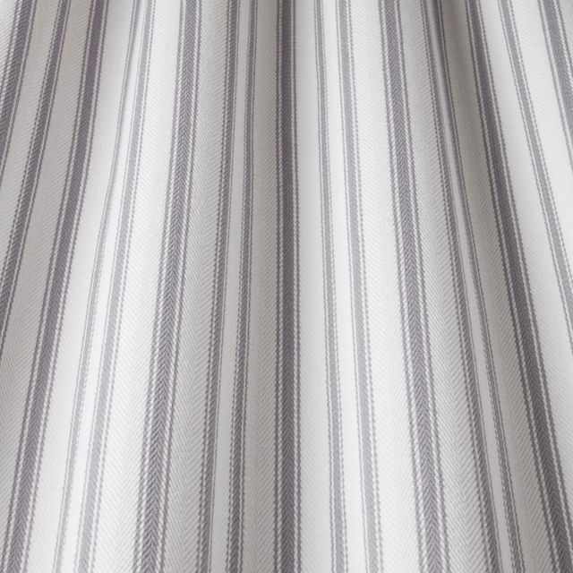Pale grey cotton fabric with fine wavy vertical stripes and soft texture