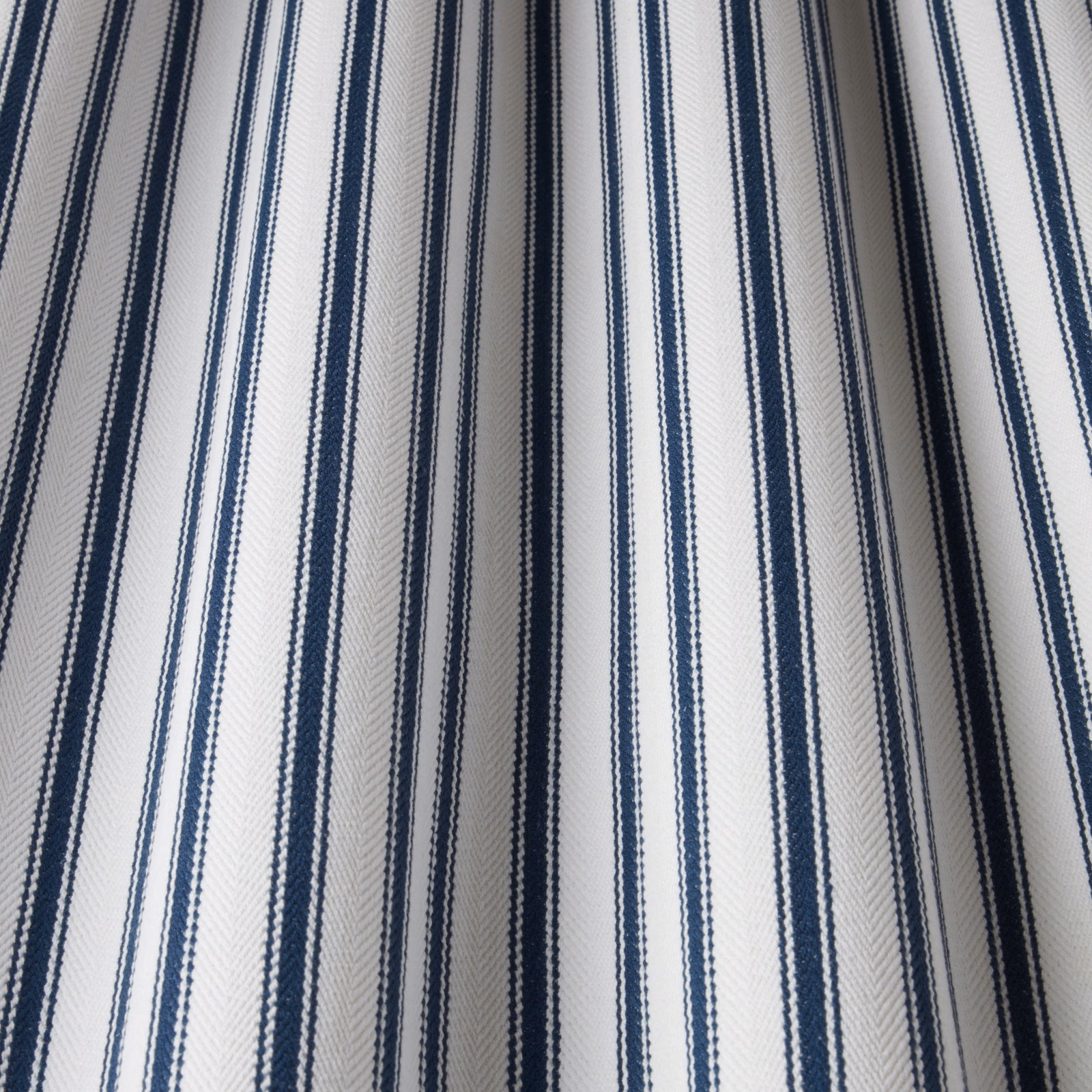 Ivory cotton fabric with narrow navy vertical stripes and subtle herringbone weave