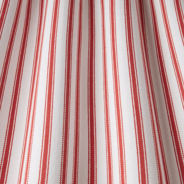 Red vertical stripe cotton fabric with subtle herringbone weave on ivory ground