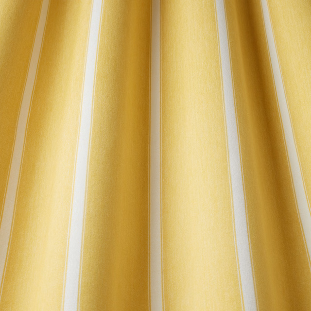 Yellow cotton fabric with wide wavy vertical stripes and pale cream borders