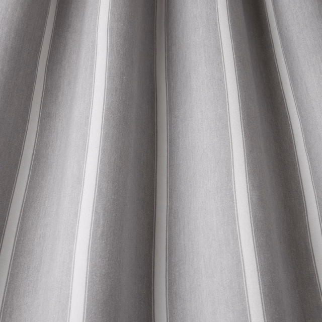 Soft grey and white wavy striped cotton fabric with a smooth woven texture