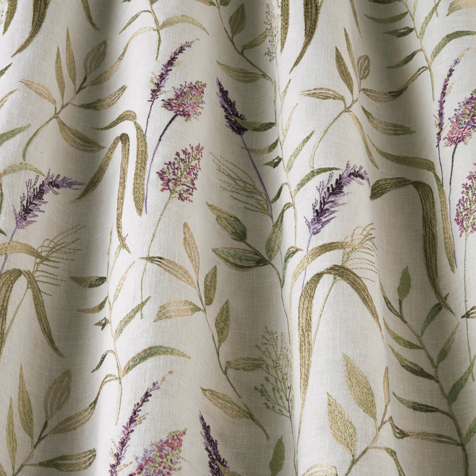 Ivory cotton fabric with trailing green leaves and lavender floral stems