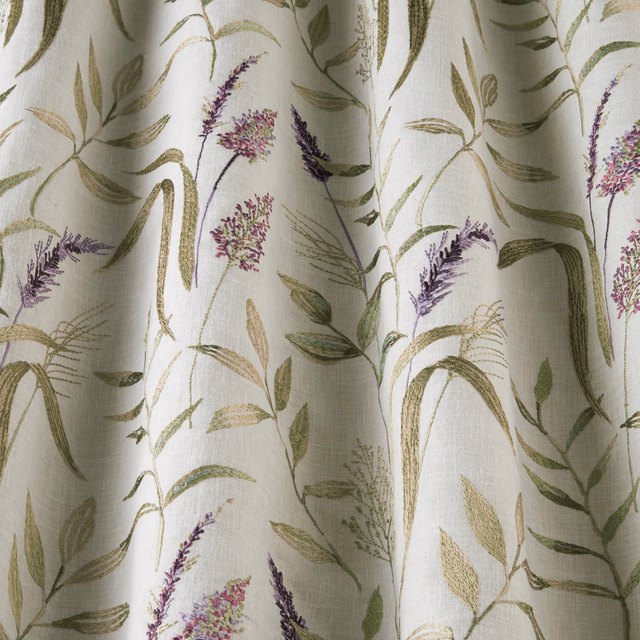 Ivory cotton fabric with trailing green leaves and lavender floral stems