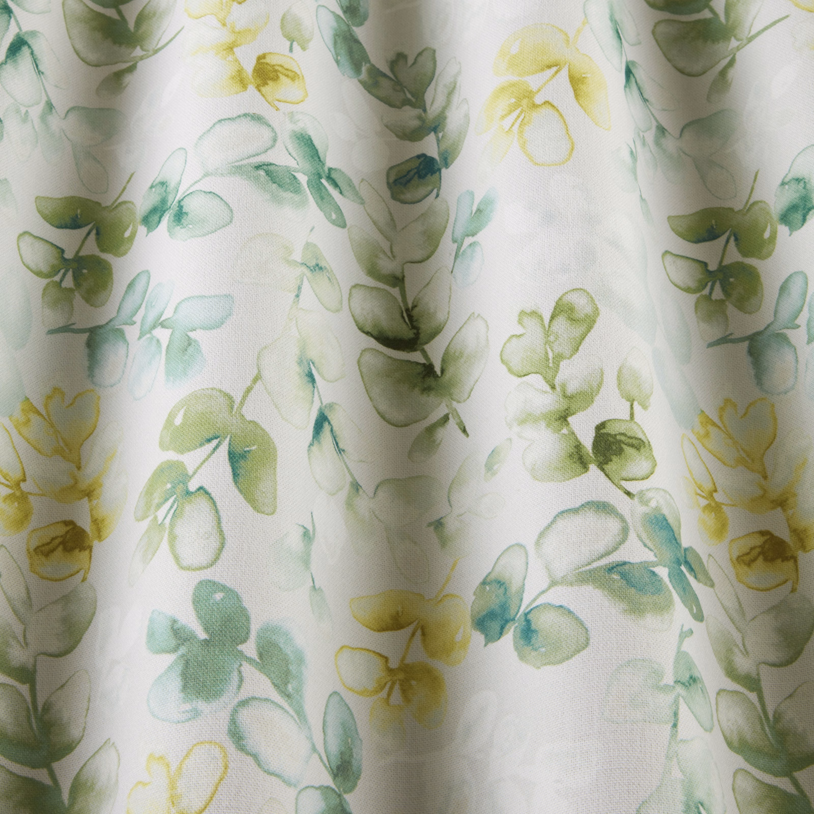 Watercolour jade and yellow-green floral cotton on a pale ivory ground