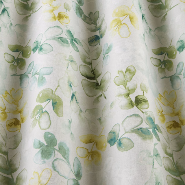 Watercolour jade and yellow-green floral cotton on a pale ivory ground