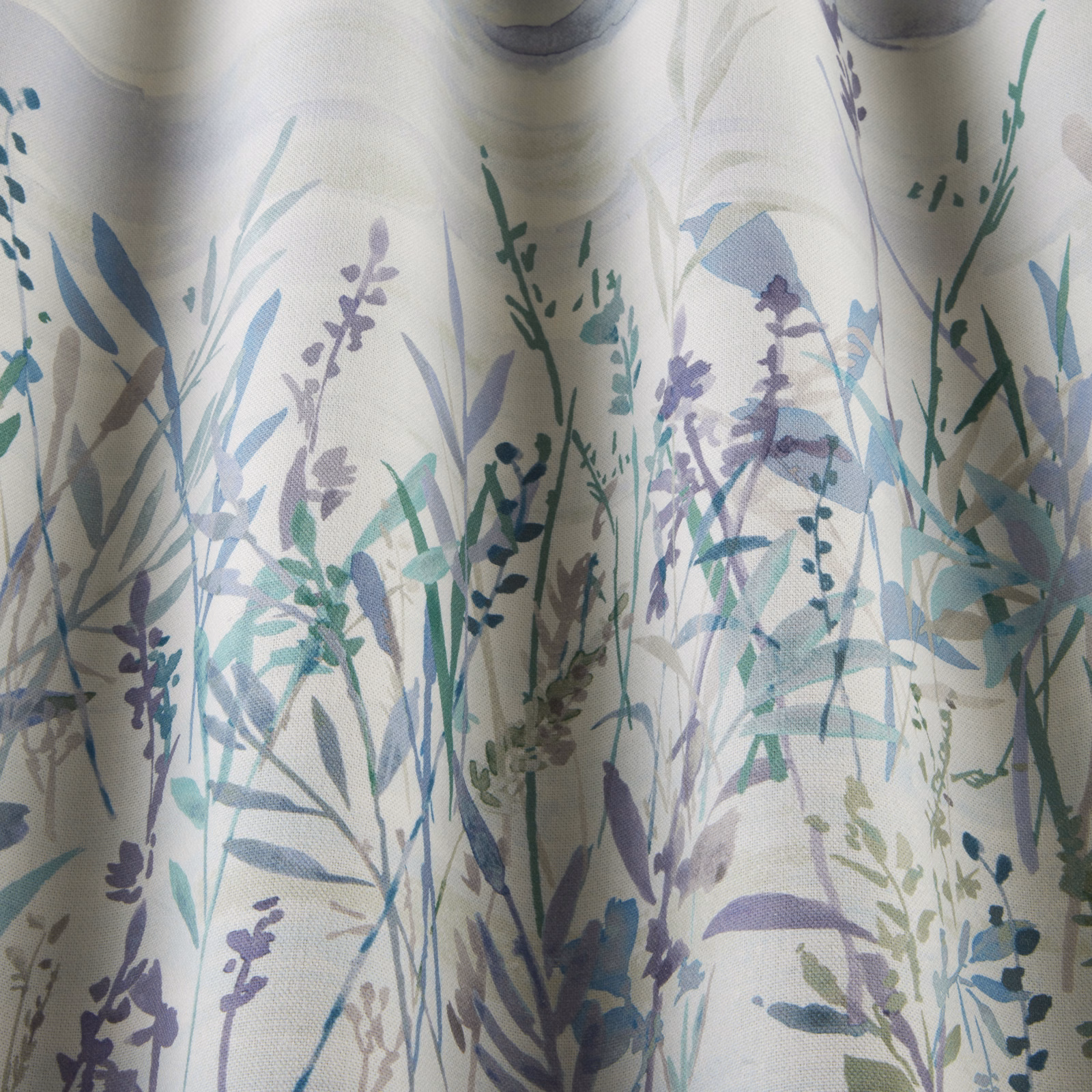 Painterly meadow stems and leaves in cobalt, lilac and sage on a pale cotton ground