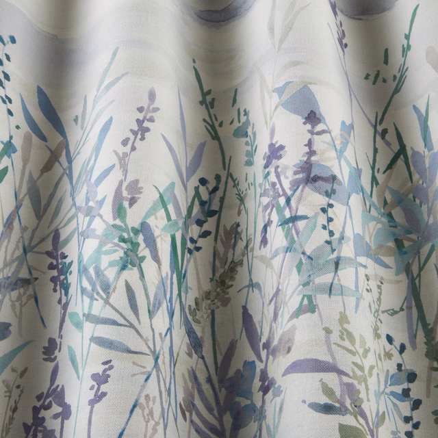 Painterly meadow stems and leaves in cobalt, lilac and sage on a pale cotton ground
