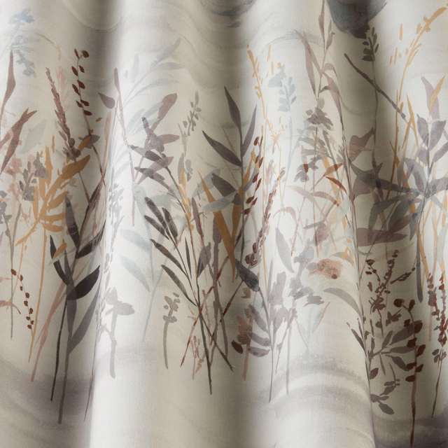 Soft floral meadow print in muted cornflower, sage and earthy tones on pale cotton