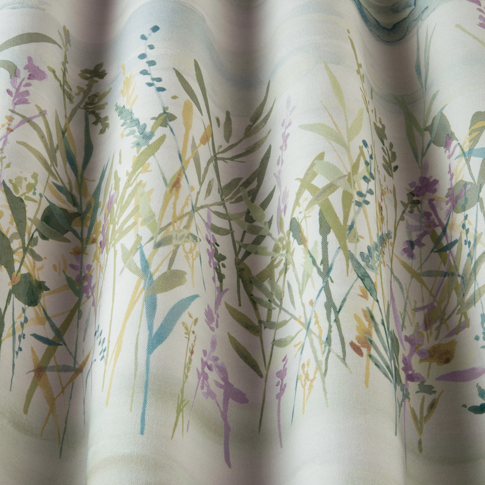 Botanical cotton fabric with jade, lilac and sage meadow stems on a pale ground