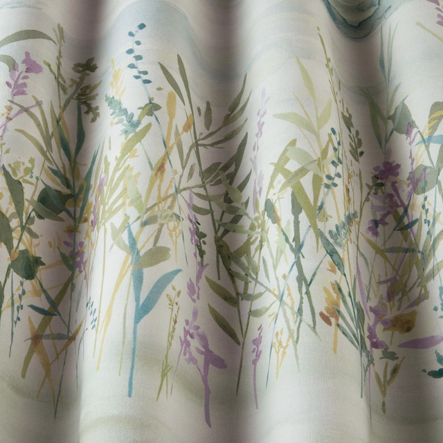 Botanical cotton fabric with jade, lilac and sage meadow stems on a pale ground