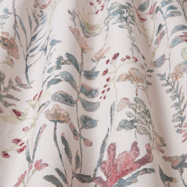 Cream cotton fabric with trailing eucalyptus green and blush botanical print