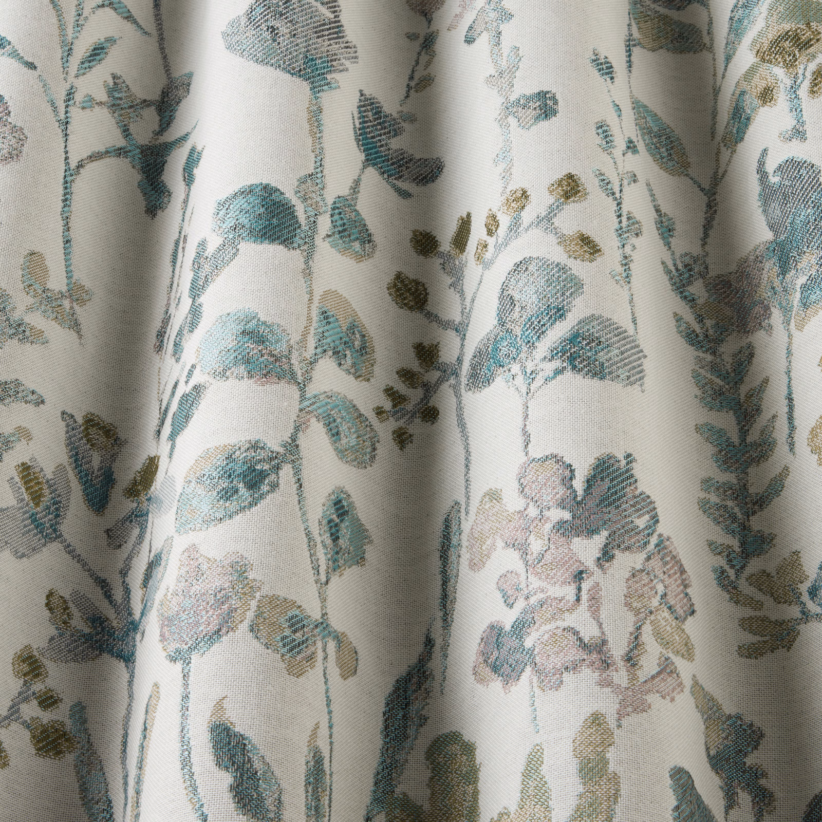 Botanical cotton fabric with wavy jade and teal leaves on a pale ground