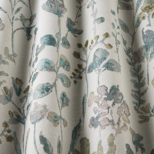 Botanical cotton fabric with wavy jade and teal leaves on a pale ground