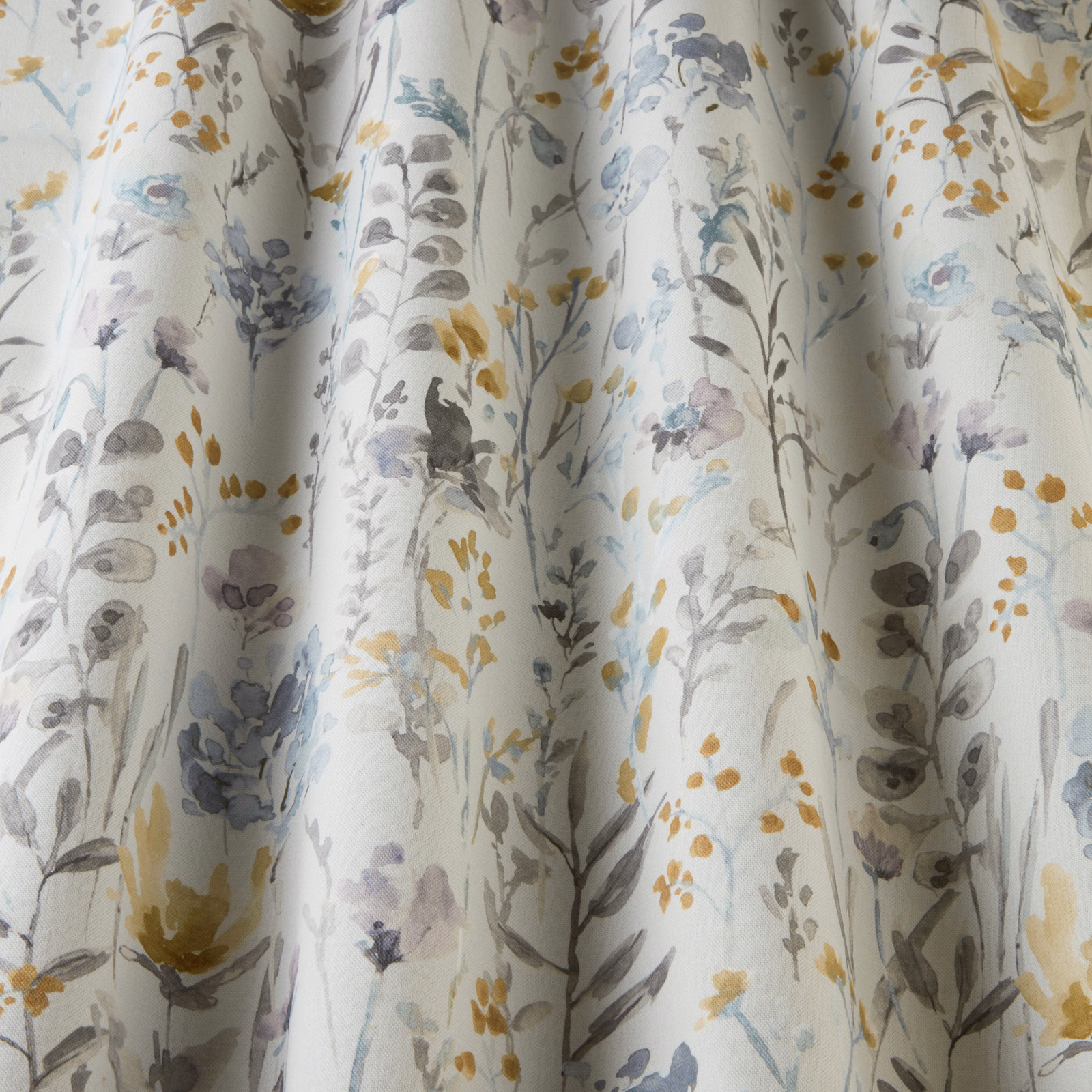 White cotton fabric with scattered cornflower wildflowers and wavy botanical stems