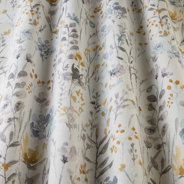 White cotton fabric with scattered cornflower wildflowers and wavy botanical stems