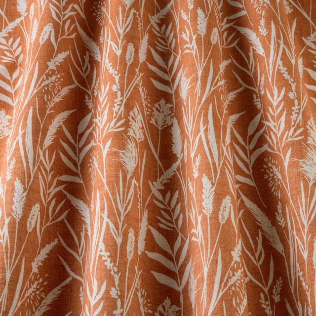 Clementine orange cotton fabric with white wild grass botanical print and soft folds