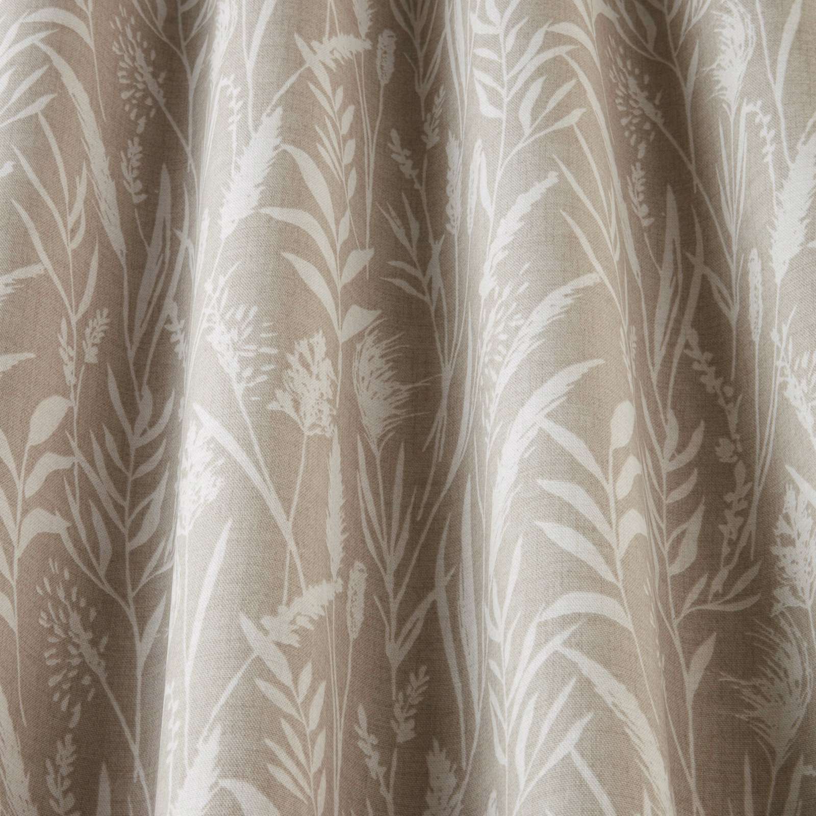 Soft beige cotton fabric with pale wavy grasses and leafy botanical print