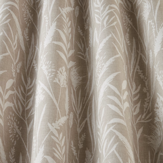 Soft beige cotton fabric with pale wavy grasses and leafy botanical print