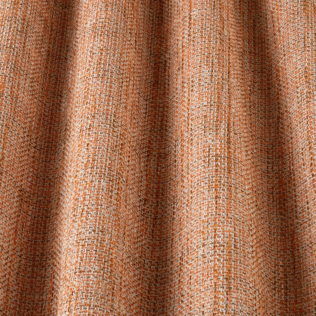 Close-up of clementine orange woven cotton fabric with a wavy textured pattern