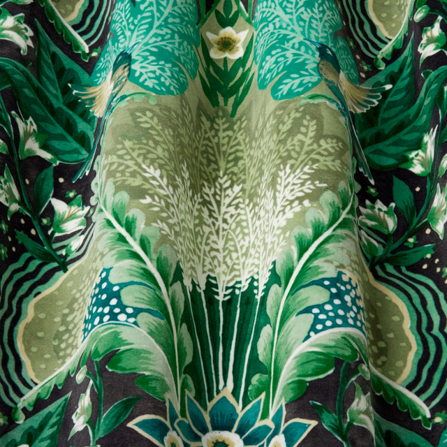 Bold absinthe green botanical fabric with wavy stripes on a dark ground