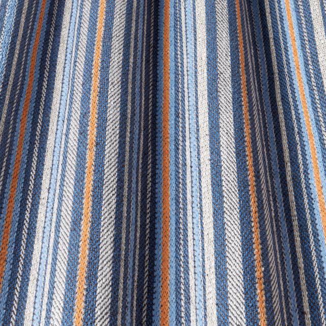Blue, ivory and rust striped woven fabric with a textured batik-style surface