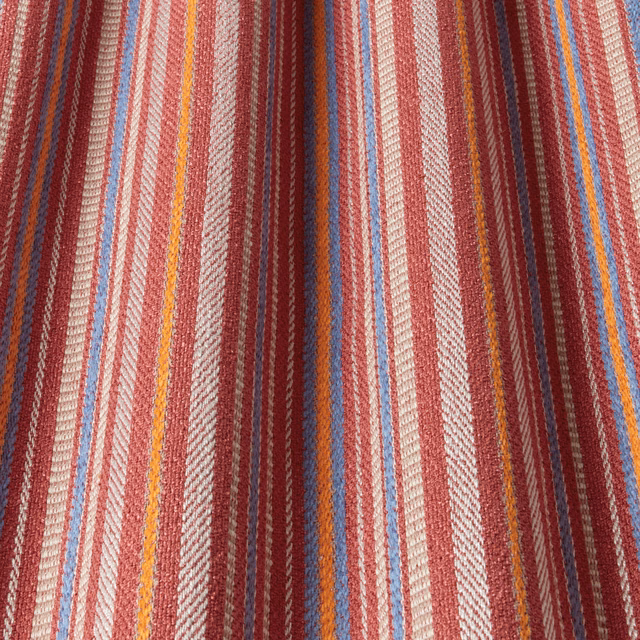 Woven stripe fabric in chili red, cream, blue and ochre with textured surface