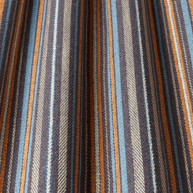 Striped woven fabric in navy, teal, rust and grey with textured finish