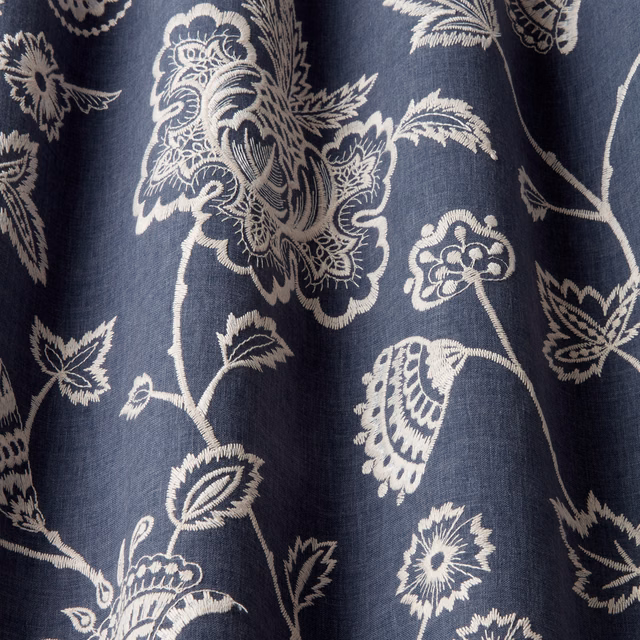 Dark navy fabric with ivory embroidered botanical vine and floral motifs