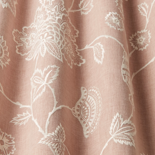 Soft orchid pink fabric with creamy embroidered floral scrolls and large motifs