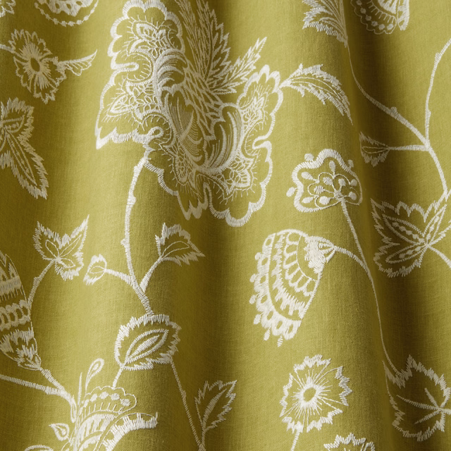 Fresh yellow-green embroidered botanical fabric with ivory floral vines and leaves