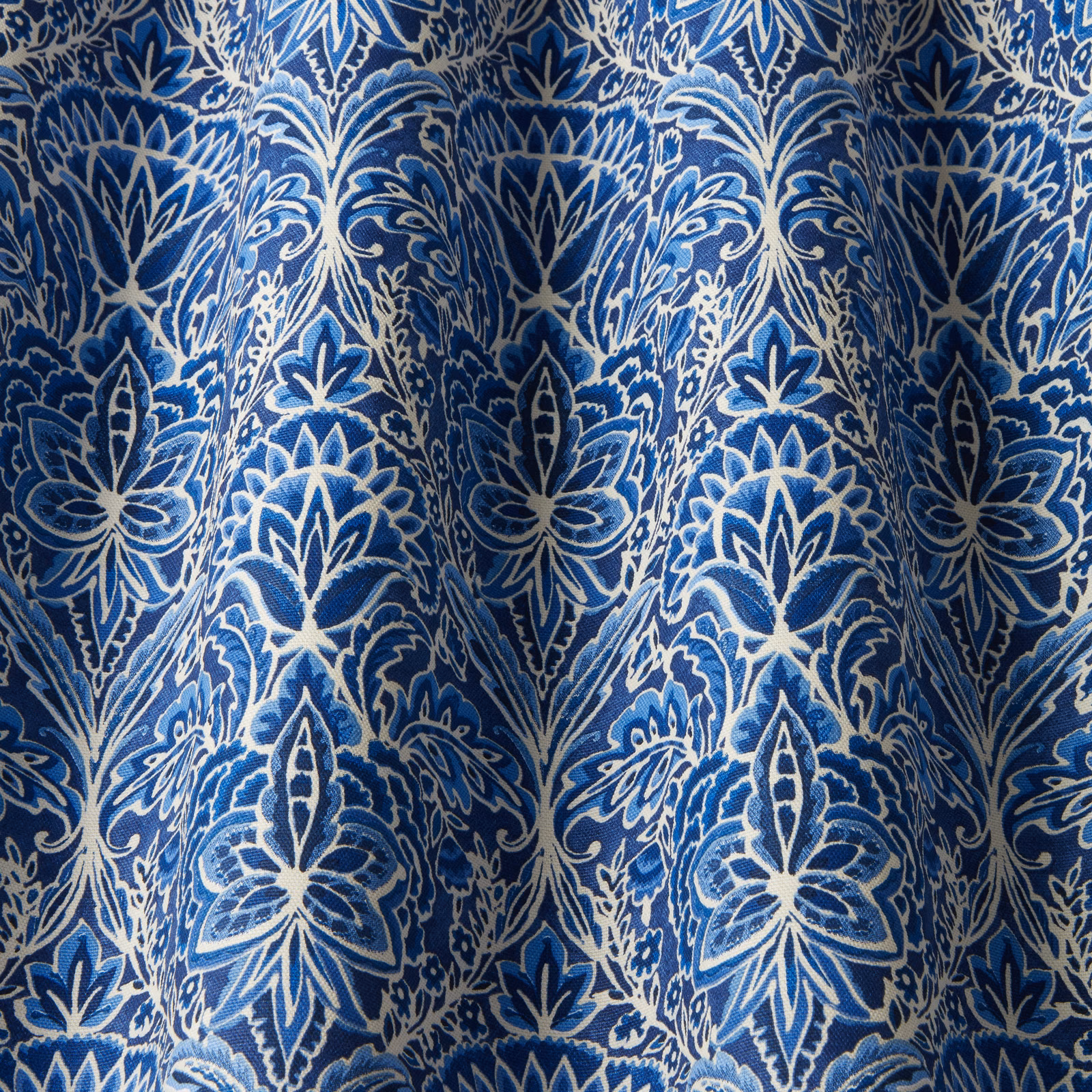 Deep cobalt damask fabric with ivory wavy leaf motifs