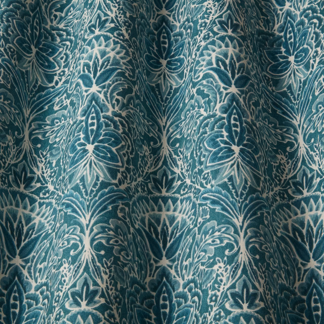 Teal cotton damask fabric with cream outlined floral pattern and soft folds