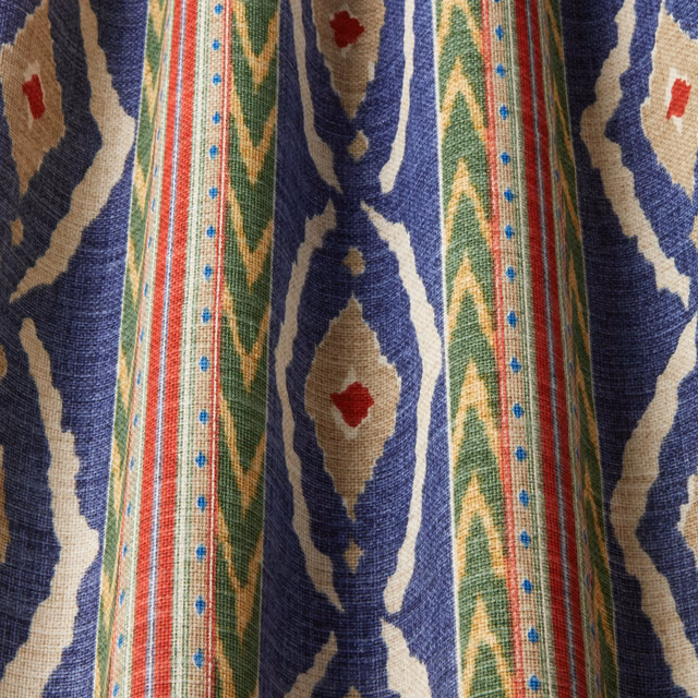 Midnight blue woven fabric with multicolour geometric stripes and ikat-style motifs