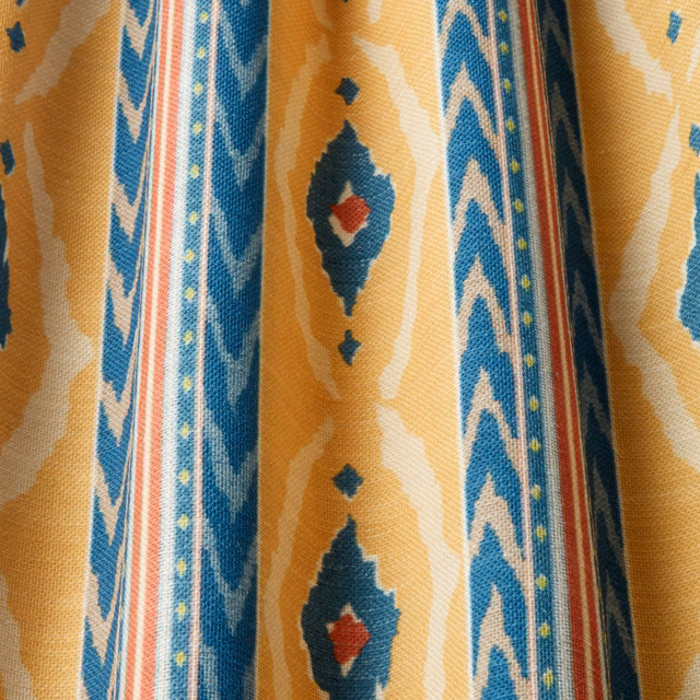 Saffron gold woven fabric with blue wavy stripes and diamond motifs